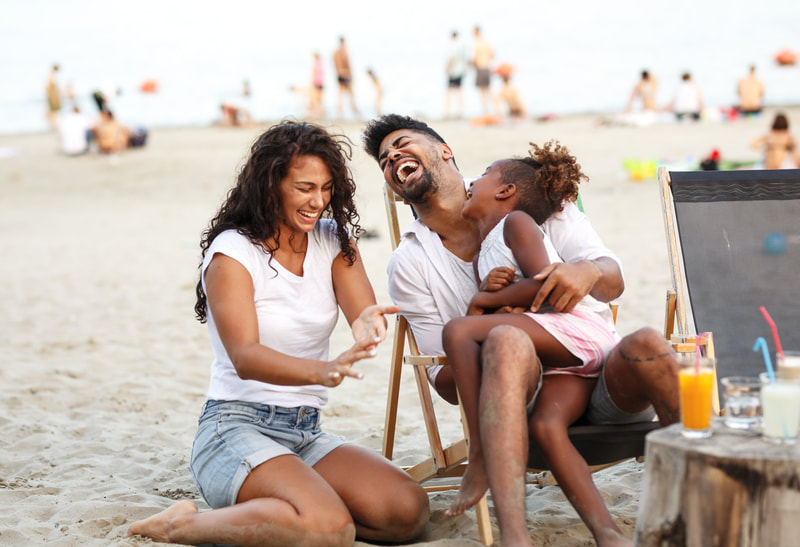 Family laughing at the beach